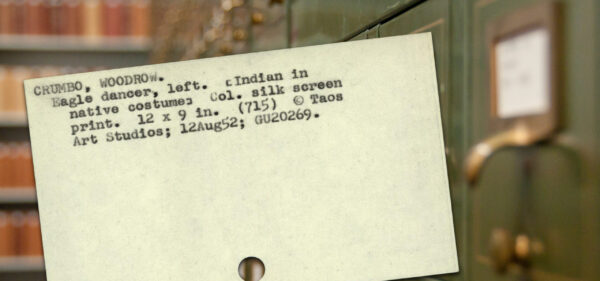 Registration record on card, with card catalog and library shelves in background. Text provides name: Crumbo, Woodrow, and title of work: Eagle dancer (left). 